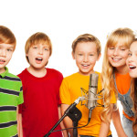 Group of 8 years old kids with microphone